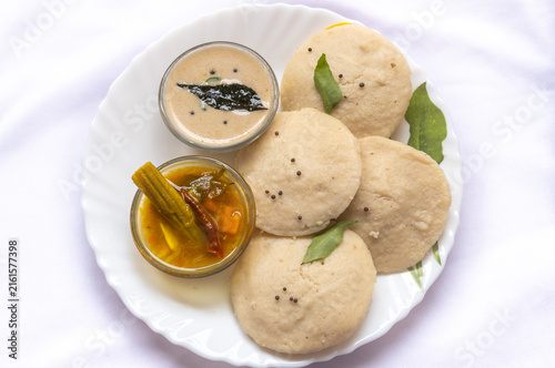 Canvastavla Top view of Idli sambar, south Indian breakfast served with coconut chutney on white plate healthy and tasty food