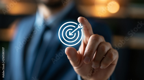 Confident businessman holding a tiny target icon with an arrow at its center between his fingers, goal-setting concept, softly blurred boardroom background, sharp cinematic focus