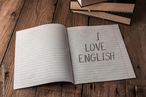 Obraz na płótnie Open Notebook with 'I Love English' on Wooden Table