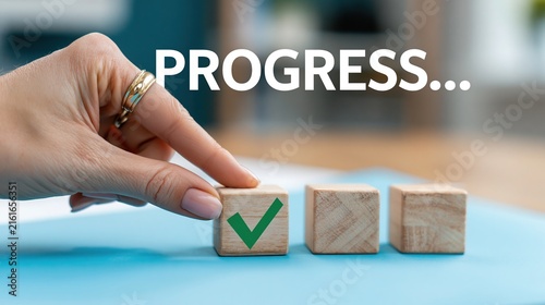 Hand placing wooden block with green check mark for project progress