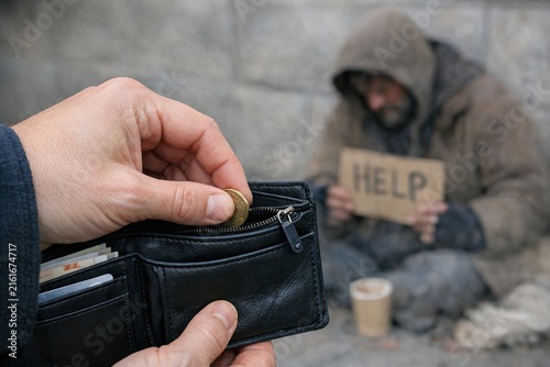 A person holding a wallet with a sign written on it, likely for identification or labeling purposes
