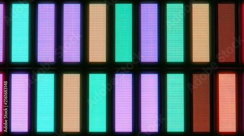 Neon grid of illuminated digital code bars in vibrant gradient colors for tech design
