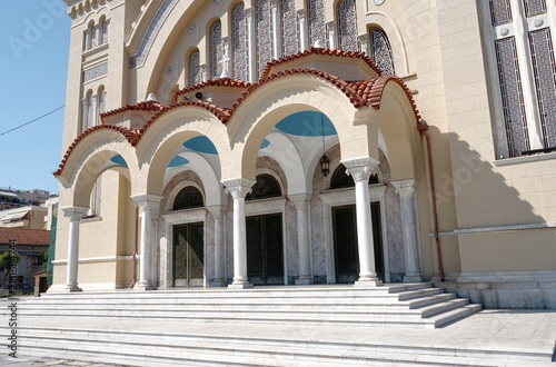 Detail view of the main entrance steps of Agios Andreas Cathedral featuring classical arches and columns, Patras, Greece.