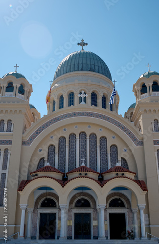 Agios Andreas church featuring prominent domes and cross, showcasing ancient architecture under clear blue sky in Patras, Greece.