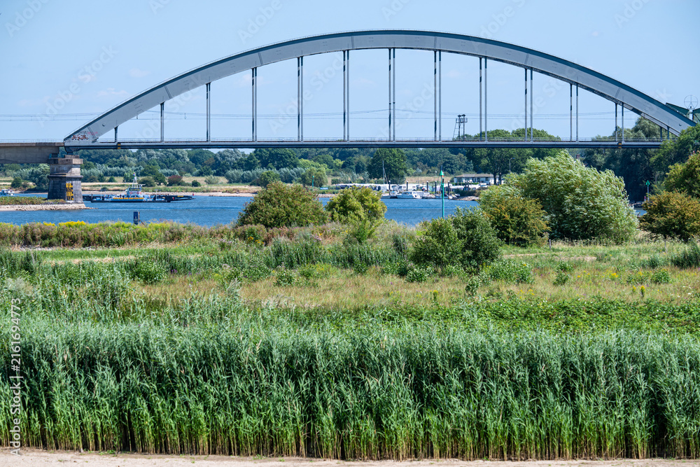 Fototapeta premium Railway arch bridge over the Lek floodplain near Culemborg.