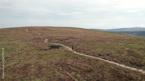 Backpacker hiker walking in Black Mountain and Twyn Llech, famous hiking location in Abergavenny, South Wales of UK.