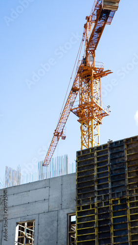 Tower crane and concrete formwork at an active construction site during the construction of a large building structure