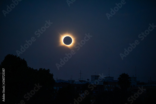 Cuadro en lienzo Total solar eclipse totality, Valencia, Spain, above a silhouette foreground