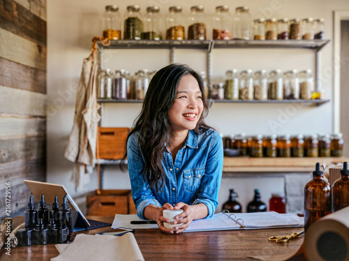 Konstfotografi Smiling Woman Working in Herbal Apothecary Shop