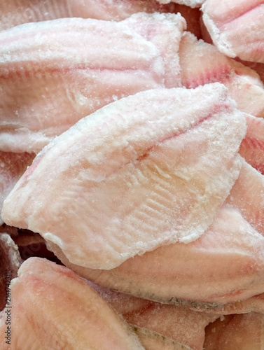 Obraz na plátně Tilapia fillets kept frozen in a supermarket refrigerator, fresh fish product pr