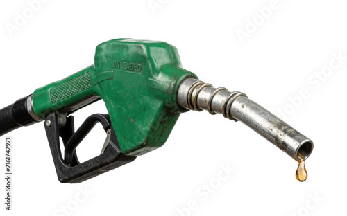Green unleaded gasoline fuel pump nozzle with a golden drop of fuel dripping from the end, symbolizing energy and transportation costs.