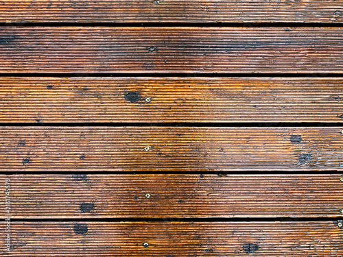 Canvas Print Wet wooden deck planks with grooved texture and visible screws, suggesting outdoor durability and natural material