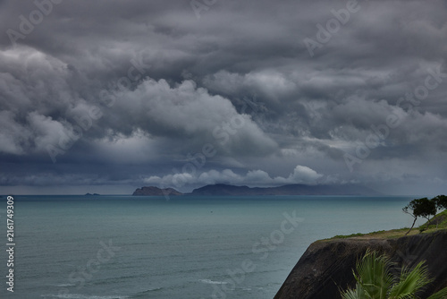 Картината върху платно storm clouds roll over San Lorenzo Island as seen from the cliffs of Miraflores, Lima, casting a moody, atmospheric veil over the Pacific coastline