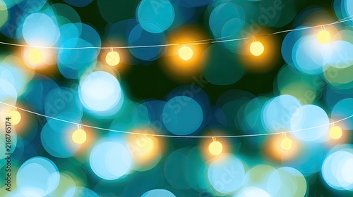 Softly glowing string lights against a bokeh background of blue and green hues
