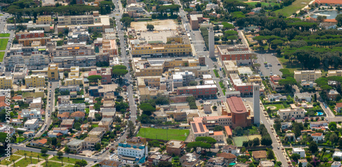 Canvas Print Aerial view of Sabaudia town centre in Italy, showing rationalist architecture, rooftops, streets and the historic tower square from above