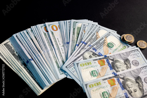 Canvas Print Stacks and fans of US hundred dollar bills on a dark background a creative concept of cash money wealth and financial success