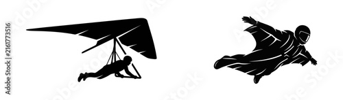 Black silhouette icons of a person hang gliding and a person flying in a wingsuit extreme sports set