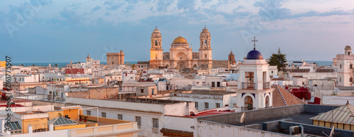 Cuadro en lienzo Cadiz Cathedral rises above whitewashed rooftops and church towers with the Atlantic Ocean visible beyond the city, Spain