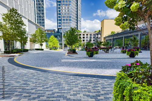Spacious Reston plaza features patterned paving, outdoor furniture, and modern architecture.