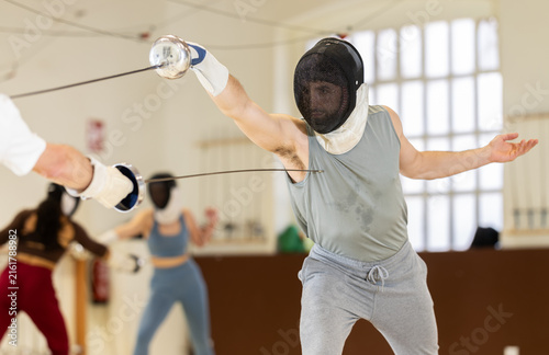 Obraz na plátne Group of fencers trains in duels and works out blows on the pillows in the gym