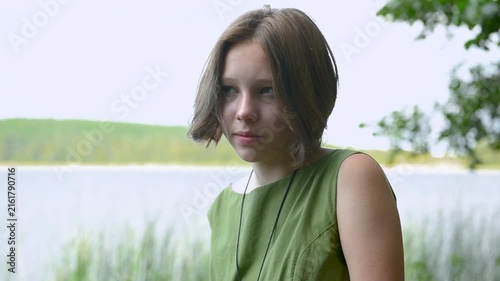 Beautiful calm young Caucasian teenage girl looking at camera.