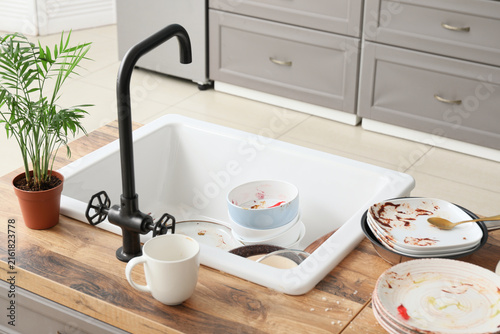 Obraz na plátně Messy kitchen sink with dirty dishes, household chores and domestic life, unwash