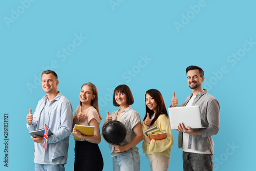Group of teachers showing thumbs-up on blue background