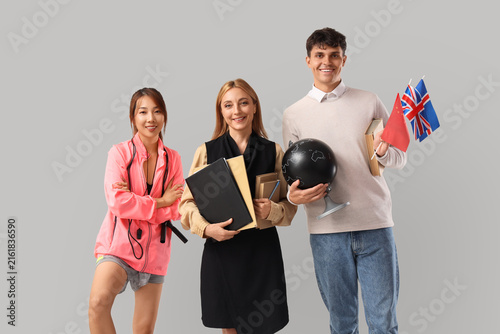 Group of teachers on light background