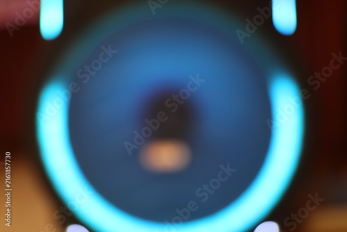 Abstract image of a speaker with vibrant blue neon lights illuminating the surrounding area