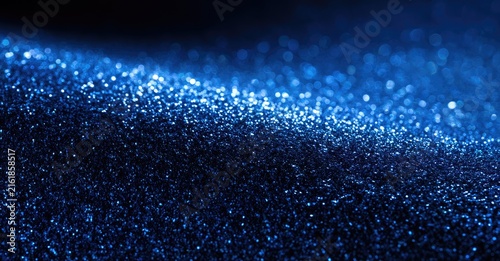 Abstract dark blue sparkling surface with soft bokeh highlights