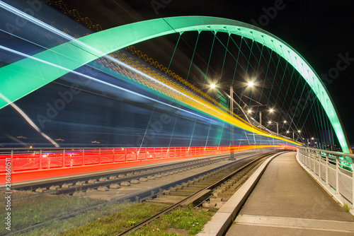  Long Exposure of a Tram Crossing the Illuminated Arch Bridge in Strasbourg, France