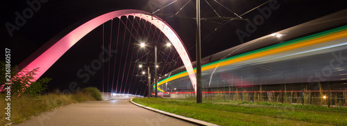  Long Exposure of a Tram Crossing the Illuminated Arch Bridge in Strasbourg, France