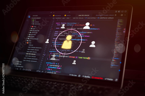 Fotografie User management and access control concept with programming code on laptop screen and digital user icons, representing account administration, permissions and software development
