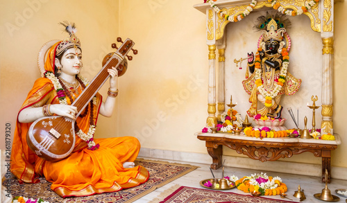 Hindu Saint Mirabai, divine mystic poet and devotee of God Krishna playing Tanpura or Sitar, Tamburo musical instrument, Worship to god Krishna at Hindu altar, Mirabai Jayanti concept