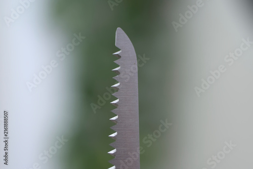 Foto Vertical closeup of open stainless steel scissors multi tool with copyspace for