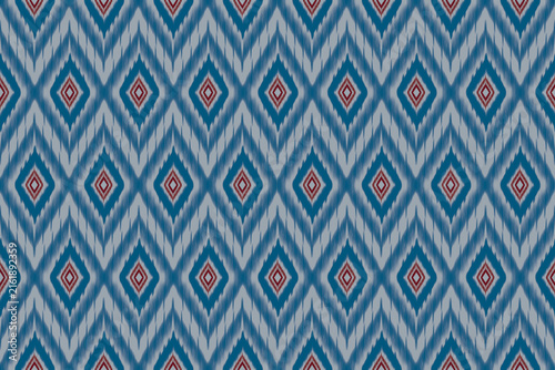 Seamless Ethnic Ikat Geometric Pattern Design with Chevron Zig-Zag and Diamond Motifs in Blue and Grey with Red Accents
