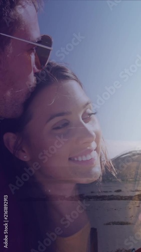 Animation of dots over happy caucasian couple on beach
