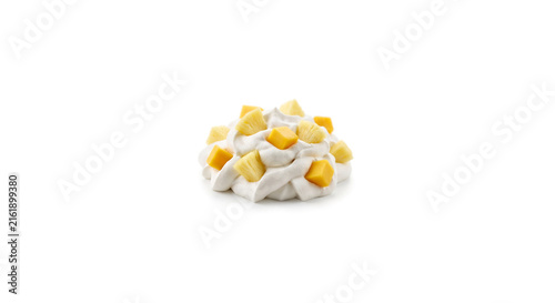 Distant shot of 5 to 10 apple mango cubes and pineapple chunks nestled on thick white coconut double cream