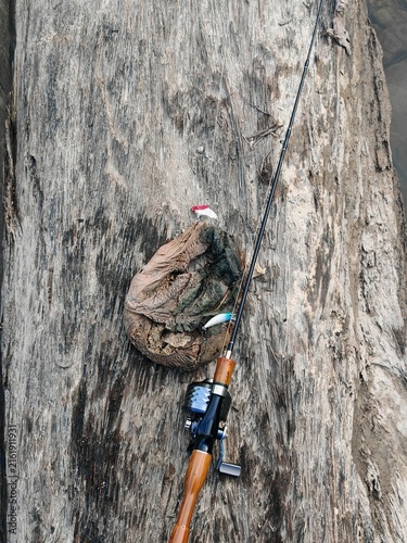 Foto Funny Fisherman Catching Baby Diapers Instead of Fish