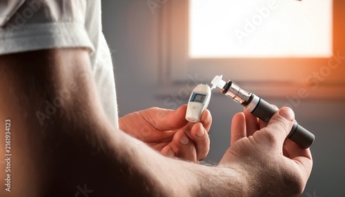 Person Holding a Glucose Monitor and an Insulin Pen for Diabetes Management
