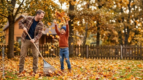 Father and son raking and playing with autumn leaves in the backyard