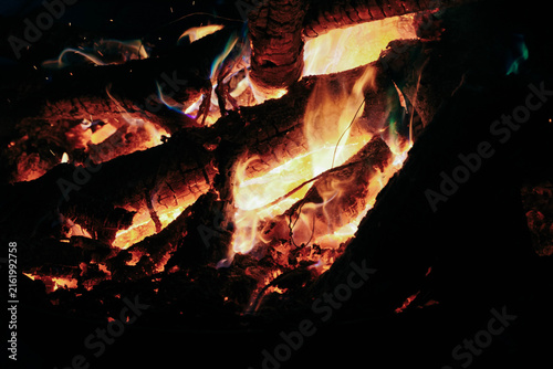 Fotografie Warm Glowing Fire in a Rustic Fireplace with Burning Wood, Bright Orange Flames
