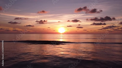 Spectacular Ocean Sunset During Golden Hour with Soft Clouds and Calm Water