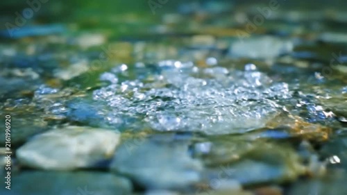 Water Splash Over Colorful River Stones