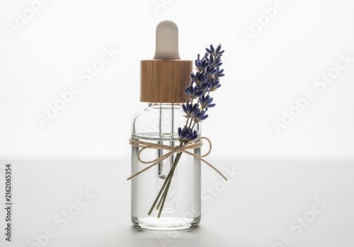 Glass dropper bottle with lavender sprig isolated on white background