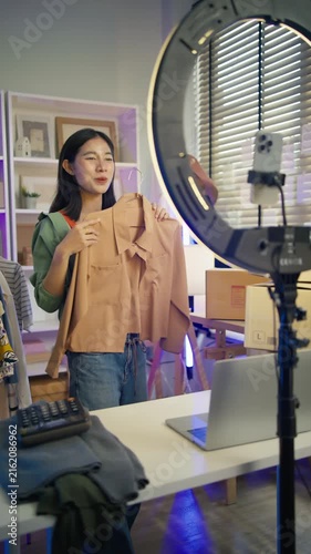 Asian woman Gen Z live streaming fashion clothing sales and looking at camera,social commerce influencer web broadcasting,e-business,e-commerce on entrepreneur,order confident,new business for gen Z