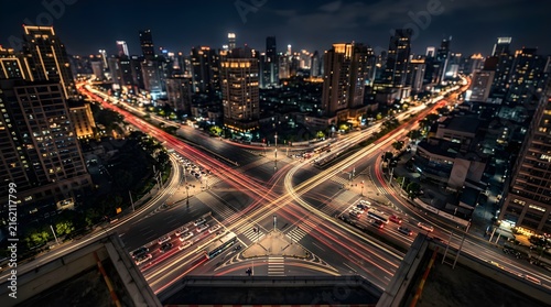 Aerial city intersection with light trails at night in a metropolis