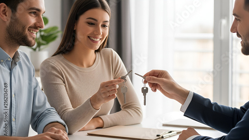 Couple receiving keys to their new home from agent