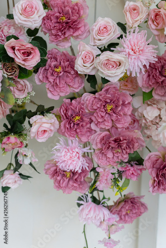 Several pink flowers against a white background.