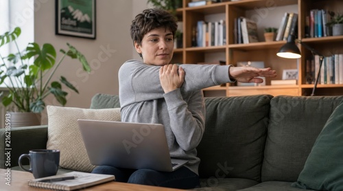 Freelance Designer Stretching Arms on Sofa with Laptop